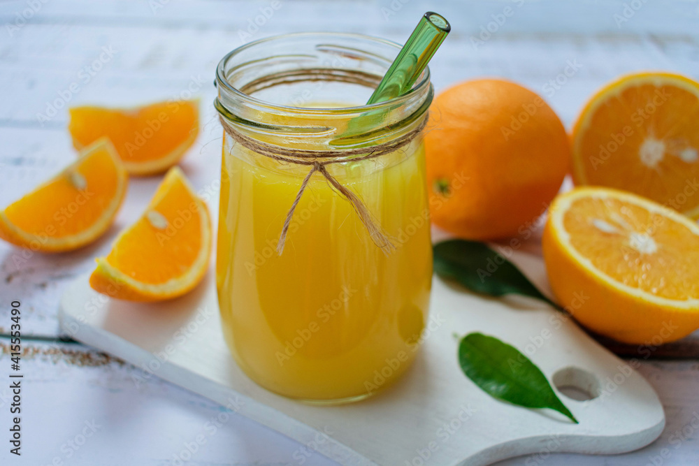 Orange juice in a jar on a light background.
Close-up. Orange juice in a jar on a light background.
Close-up.