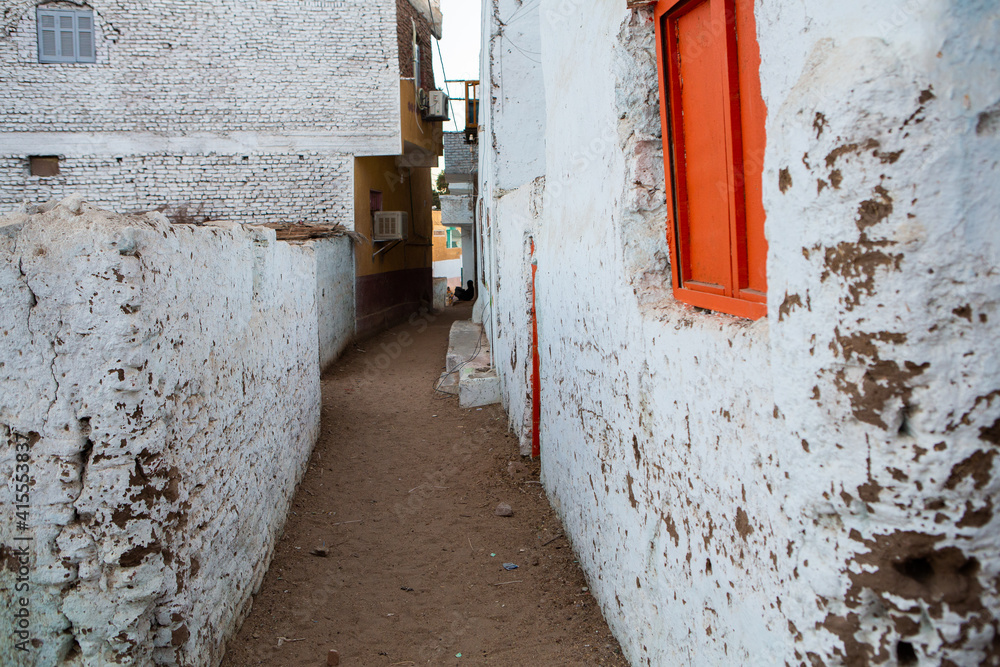 Colourful exterior wall of a Nubian house in Egypt. Typical African village houses facade. Medieval street.