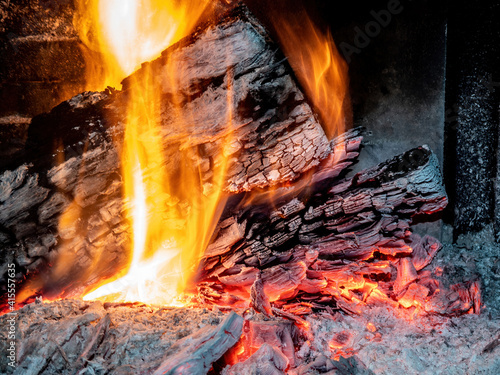 Burning billets in fireplace as abstract background