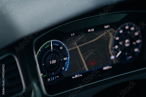 Modern electric car close up view of tachometer and dashboard with backlight