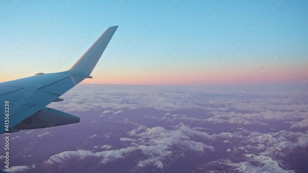 Wing of an airplane in the sunset with clouds Wing of an airplane in the sunset with clouds