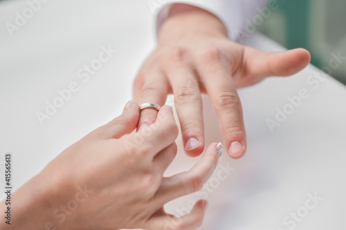 The bride puts her wedding ring on her groom s finger. High quality photo