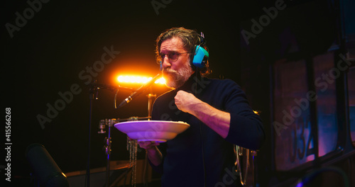 Man eating and talking while recording movie soundtrack
