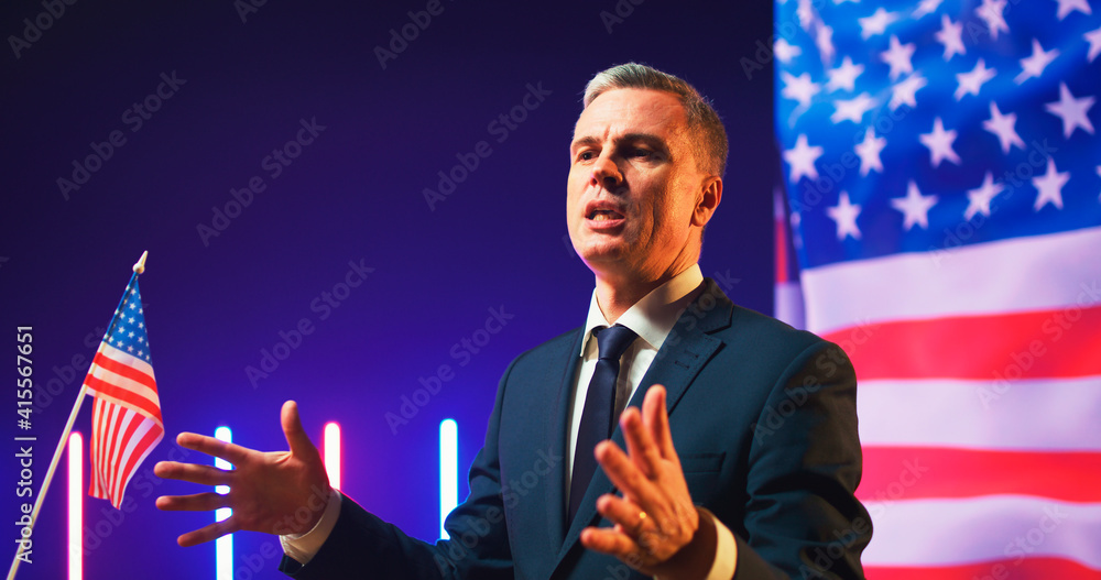 Confident American politician speaking from podium - obrazy, fototapety, plakaty 