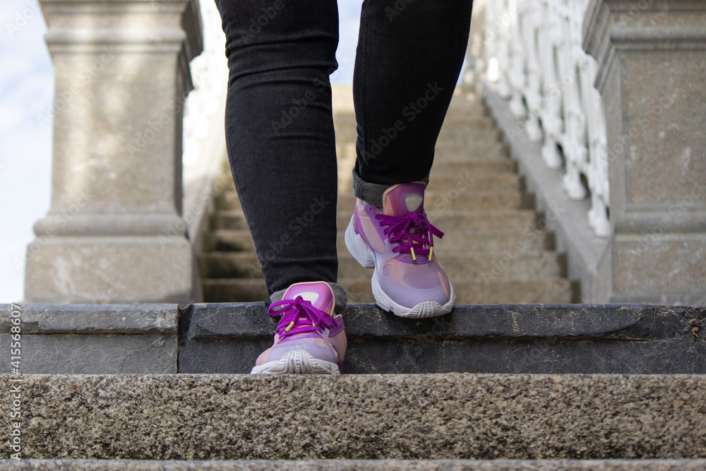 close-up of sneakers walking down the stairs close-up of sneakers walking down the stairs