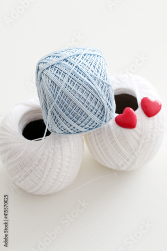 blue and white crochet yarn with red hearts