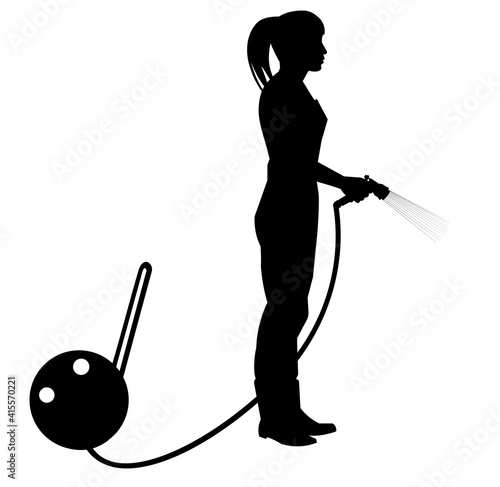 A woman gardener or farmer silhouette waters the plants with a garden hose