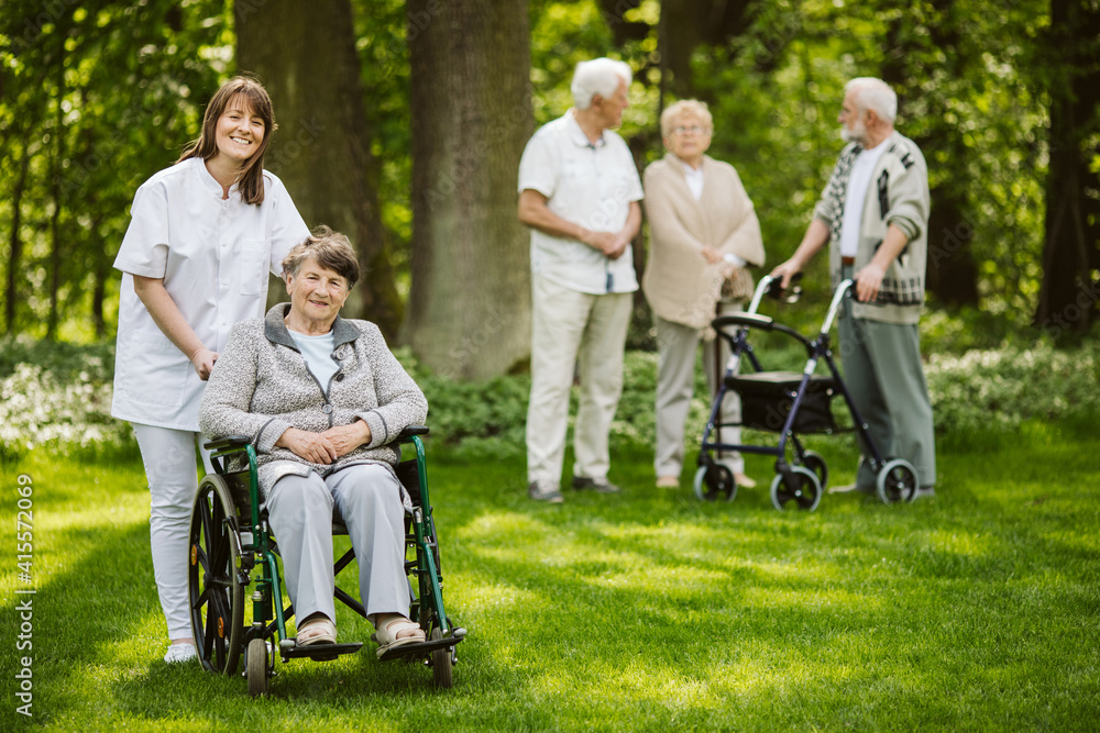 Caregiver and elder woman on the wheelchair Caregiver and elder woman on the wheelchair