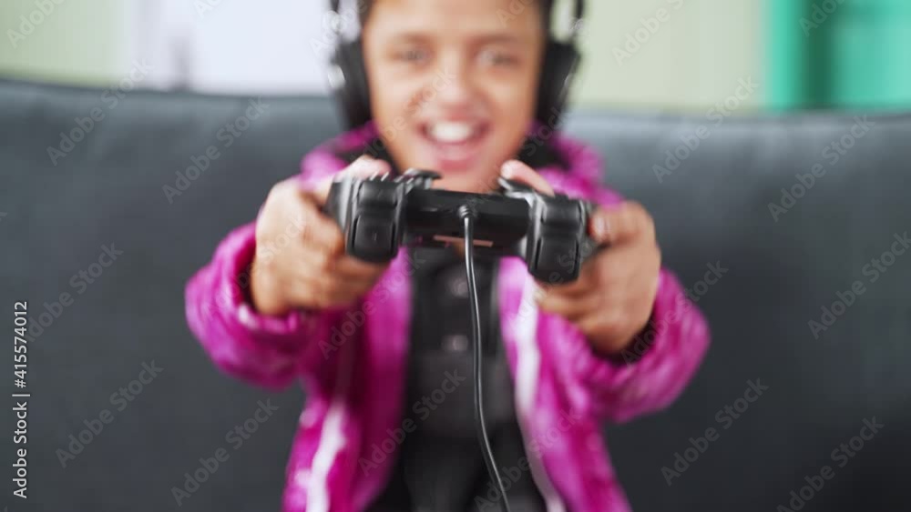 Close up selective focus on joystick, kid enjoying videogame using gamepad at home while sitting on sofa Close up selective focus on joystick, kid enjoying videogame using gamepad at home while sitting on sofa