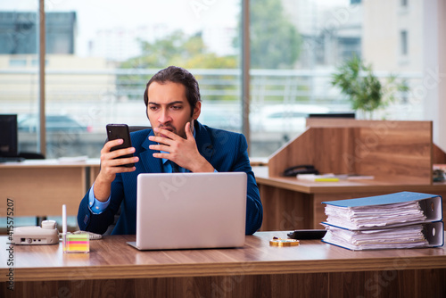 Young male employee working in the office