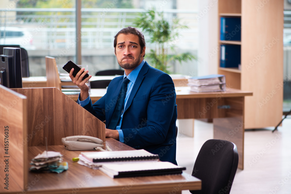 Young male employee working in the office Young male employee working in the office