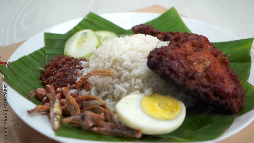 Nasi Lemak dish with chicken drum stick in slow motion Nasi Lemak dish with chicken drum stick in slow motion