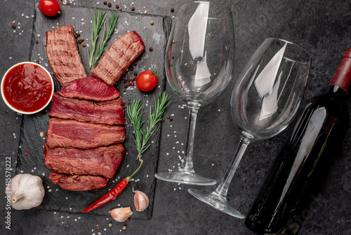 Easter bunny from beef with different roasting of meat
, wine bottle and glasses on a stone background with copy space for your text. Easter celebration concept