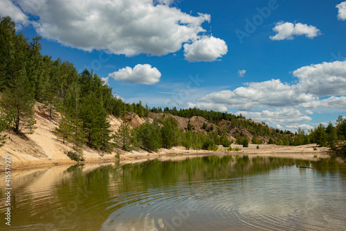 Large quarry for the extraction of clay, inactive, reclaimed. Trees grew on its territory and a lake with clear water and sandy beaches was formed.