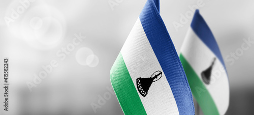 Small national flags of the Lesotho on a light blurry background