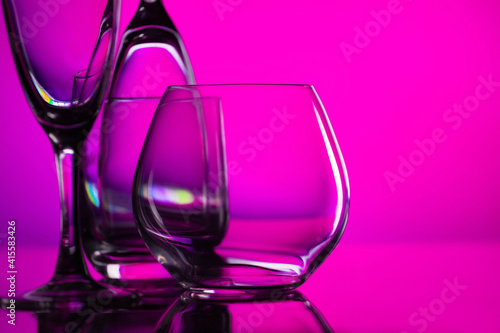 glasses of whiskey and champagne on a bright multicolored background.