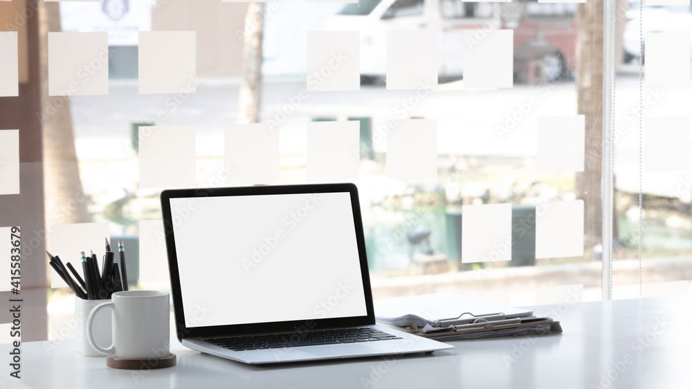 Laptop computer with mockup or blank screen on white desk in workspace and copy space concept Laptop computer with mockup or blank screen on white desk in workspace and copy space concept