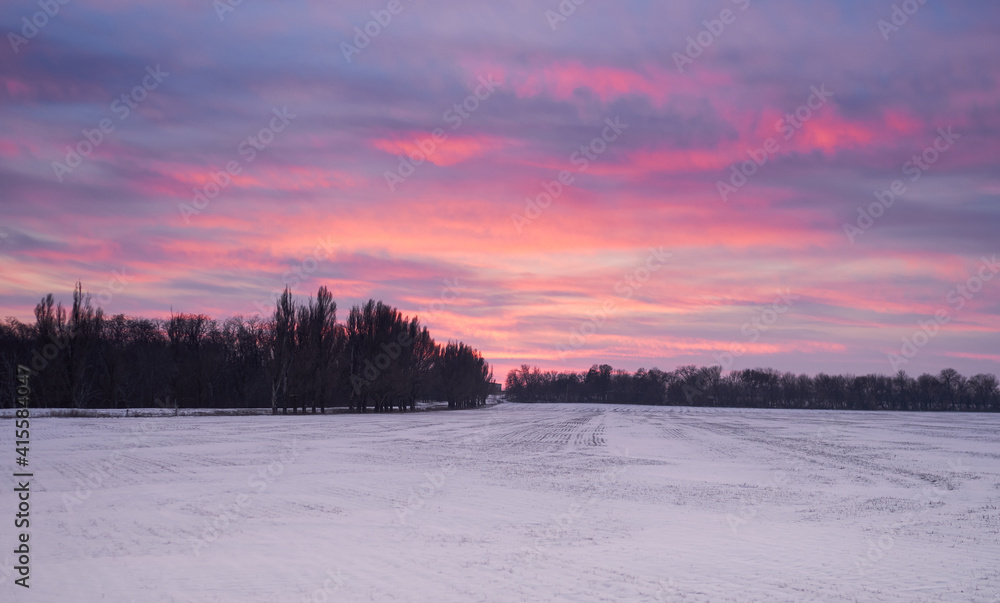 a field covered with snow at sunset a field covered with snow at sunset