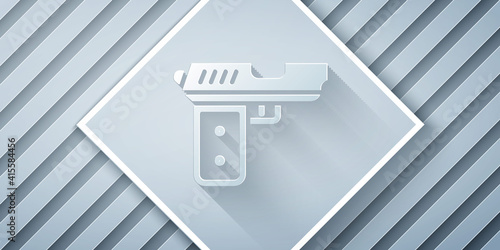 Paper cut Pistol or gun icon isolated on grey background. Police or military handgun. Small firearm. Paper art style. Vector.