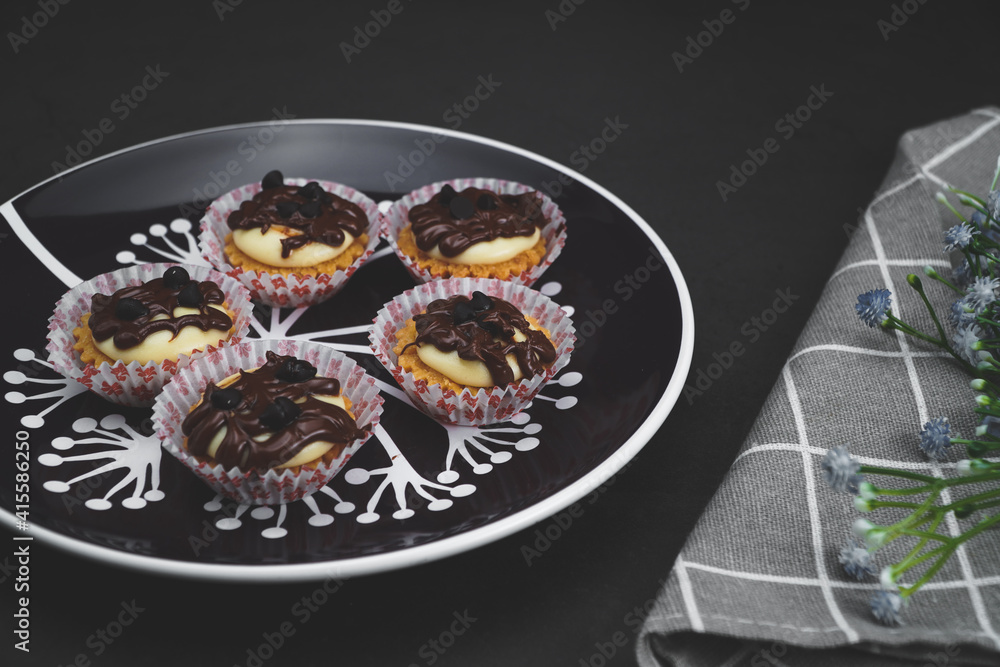 selective focus of cheese tart on the table with a cinematic light. selective focus of cheese tart on the table with a cinematic light.