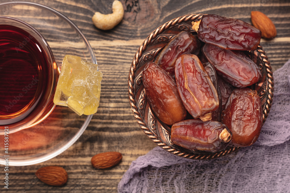 Ramadan concept with a cup of tea and dried of dates. Top view Ramadan concept with a cup of tea and dried of dates. Top view