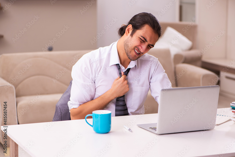 Young male employee working from home during pandemic Young male employee working from home during pandemic