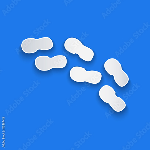 Paper cut Human footprints shoes icon isolated on blue background. Shoes sole. Paper art style. Vector.