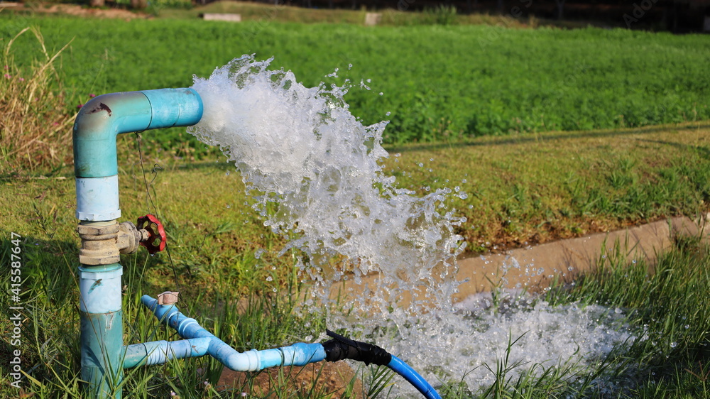 Water flowing out of PVC pipe. Silver high water pressure gushes from