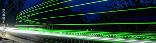 green car lights at night. long exposure