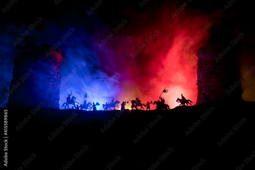 Medieval battle scene. Silhouettes of figures as separate objects, fight between warriors at night. Creative artwork decoration. Foggy background.
