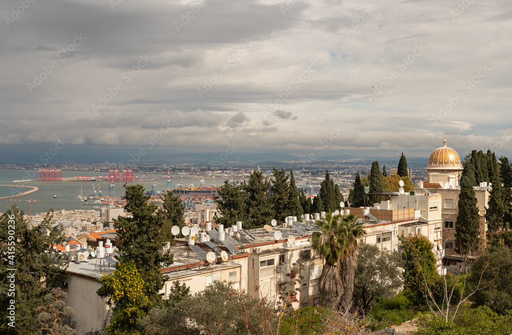 View on a rainy day from Mount Carmel to the Bahai Temple, downtown, the port and the Mediterranean Sea and Haifa city, in Israel.