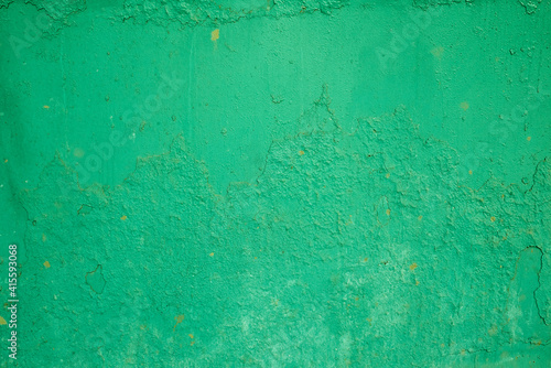 the texture of an old green painted wall. rough background.
