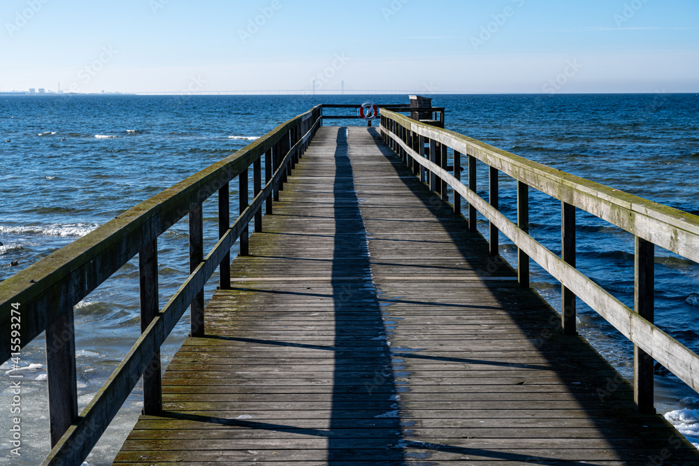  A picture of a boardwalk in an Ice covered ocean bay. Picture from Lomma, southern Sweden