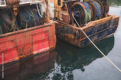 Nautical detail of rusty, vintage commercial fishing boats at Mallaig village harbour in the Scottish Highlands, west coast Scotland photo