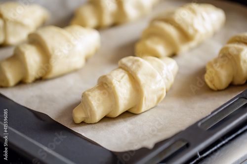 Raw croissant dough on tray - cooking pastry © 8H