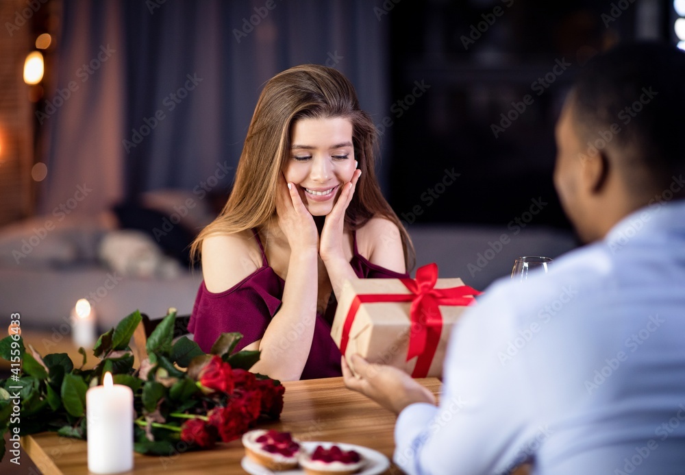 Happy International Women's Day. Loving Black Man Giving Gift To Excited Girlfriend Happy International Women's Day. Loving Black Man Giving Gift To Excited Girlfriend