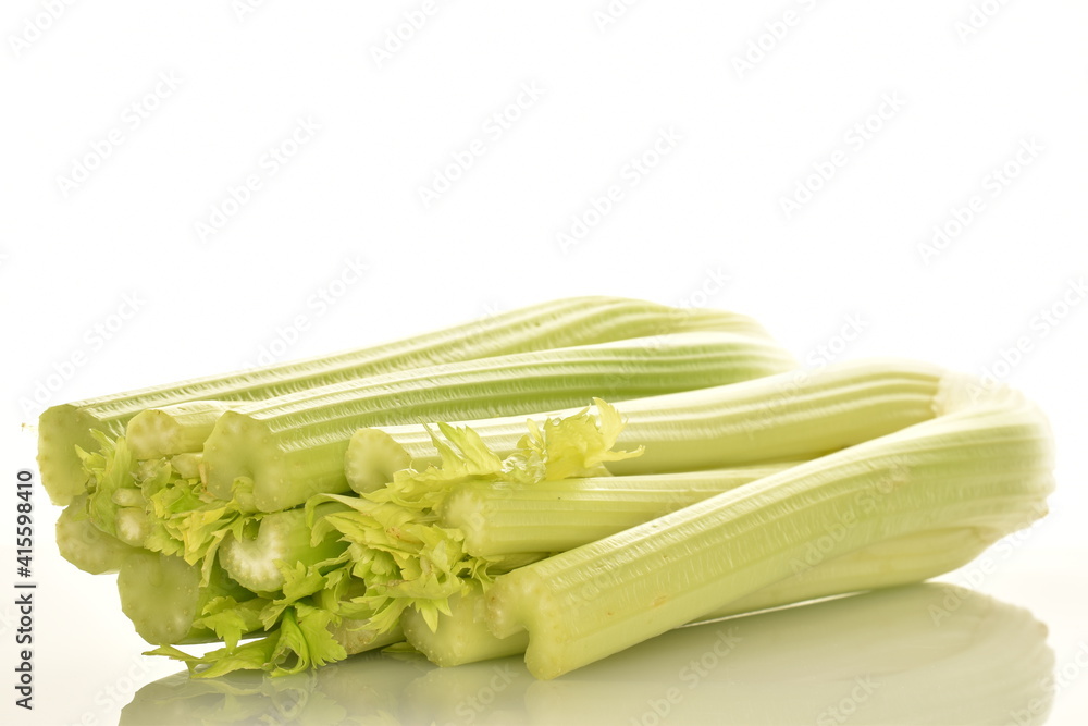 Two light green natural, juicy stalks of celery, close-up, isolated on white. Two light green natural, juicy stalks of celery, close-up, isolated on white.