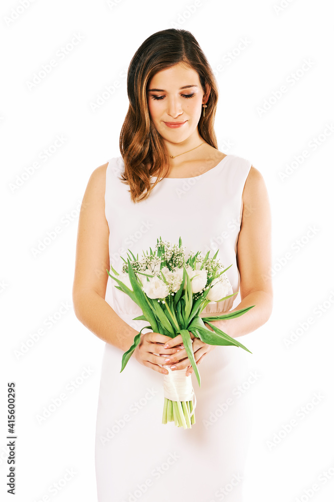 Portrait of young pretty woman wearing white dress, holding tulips Portrait of young pretty woman wearing white dress, holding tulips