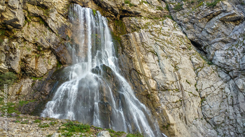 The huge Gegsky waterfall gushing with a strong stream from the rock in the vastness of Abkhazia