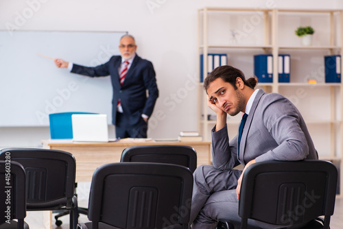 Two businessmen in the classroom in pandemic concept