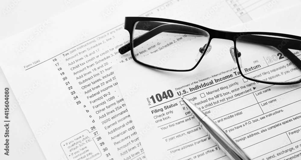 United States American IRS Internal Revenue Service income tax filing form 1040 for revenue reporting preparation with financial papers United States American IRS Internal Revenue Service income tax filing form 1040 for revenue reporting preparation with financial papers
