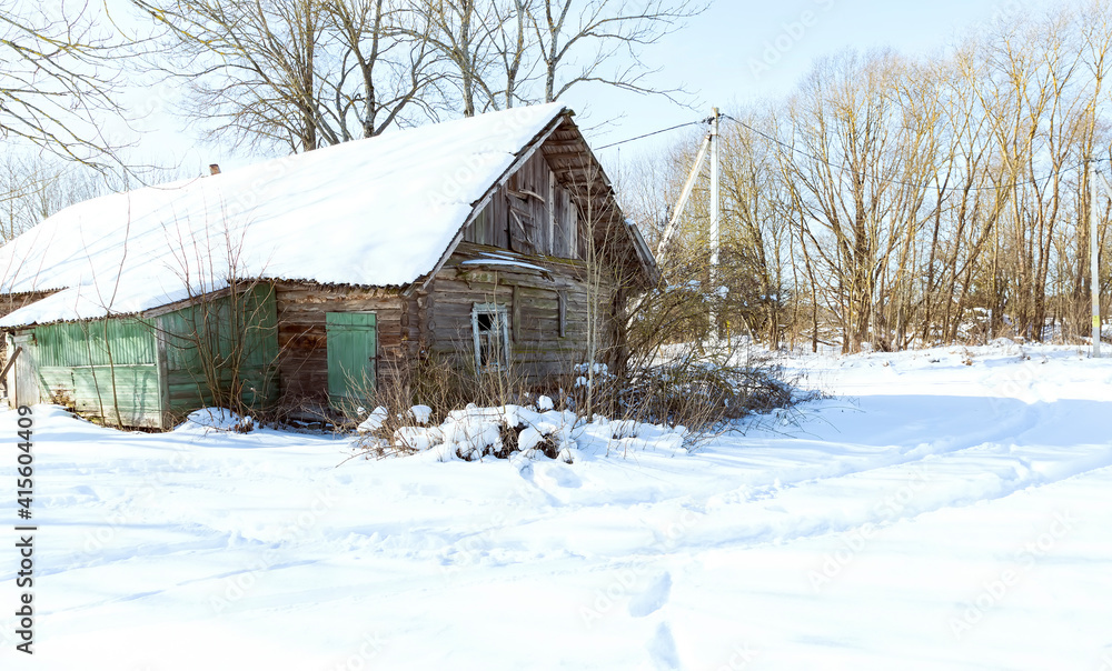 Old abandoned wooden house in winter