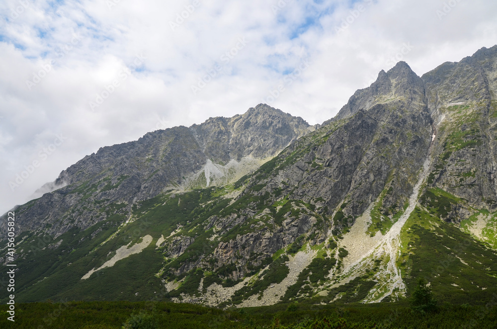 Mountain landscape. High mountains in the low clouds. Nature of High Tatras mountains. Slovakia, Europe.