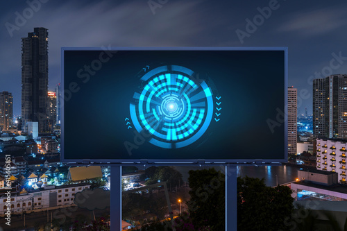 Information flow hologram on road billboard, night panorama city view of Bangkok. The largest technological center in Southeast Asia. The concept of programming science.