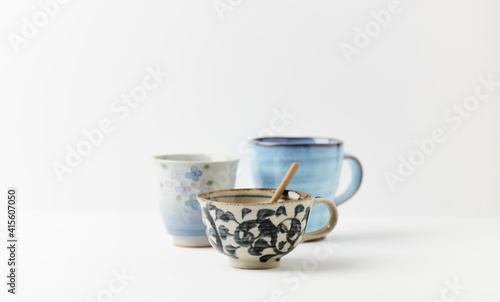 Traditional, handcrafted ceramic on bright wooden background. Soft focus. Copy space.