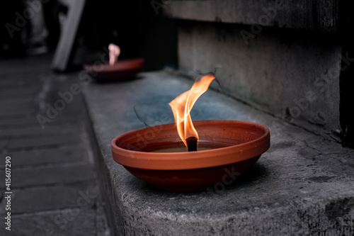 burning candle in a bowl