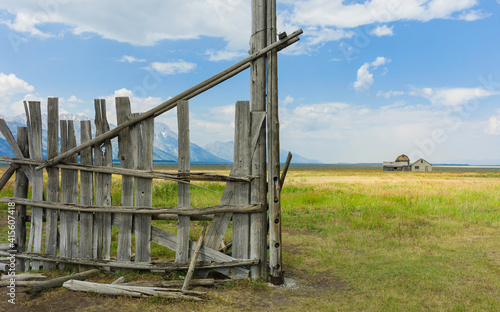 Wooden fence of early Mormon homestead with mountains as backdrop. Jackson, USA.