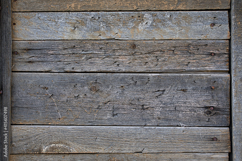 A wooden wall made of planks with peeling green paint. Background