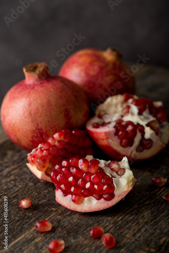 Fresh ripe pomegranate on a wooden background, selective focus