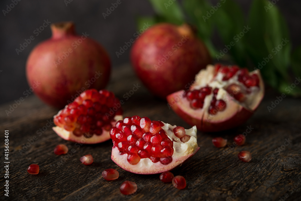 Fresh ripe pomegranate on a wooden background Fresh ripe pomegranate on a wooden background